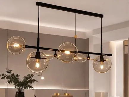 Linear pendant with glass globes over a dining table